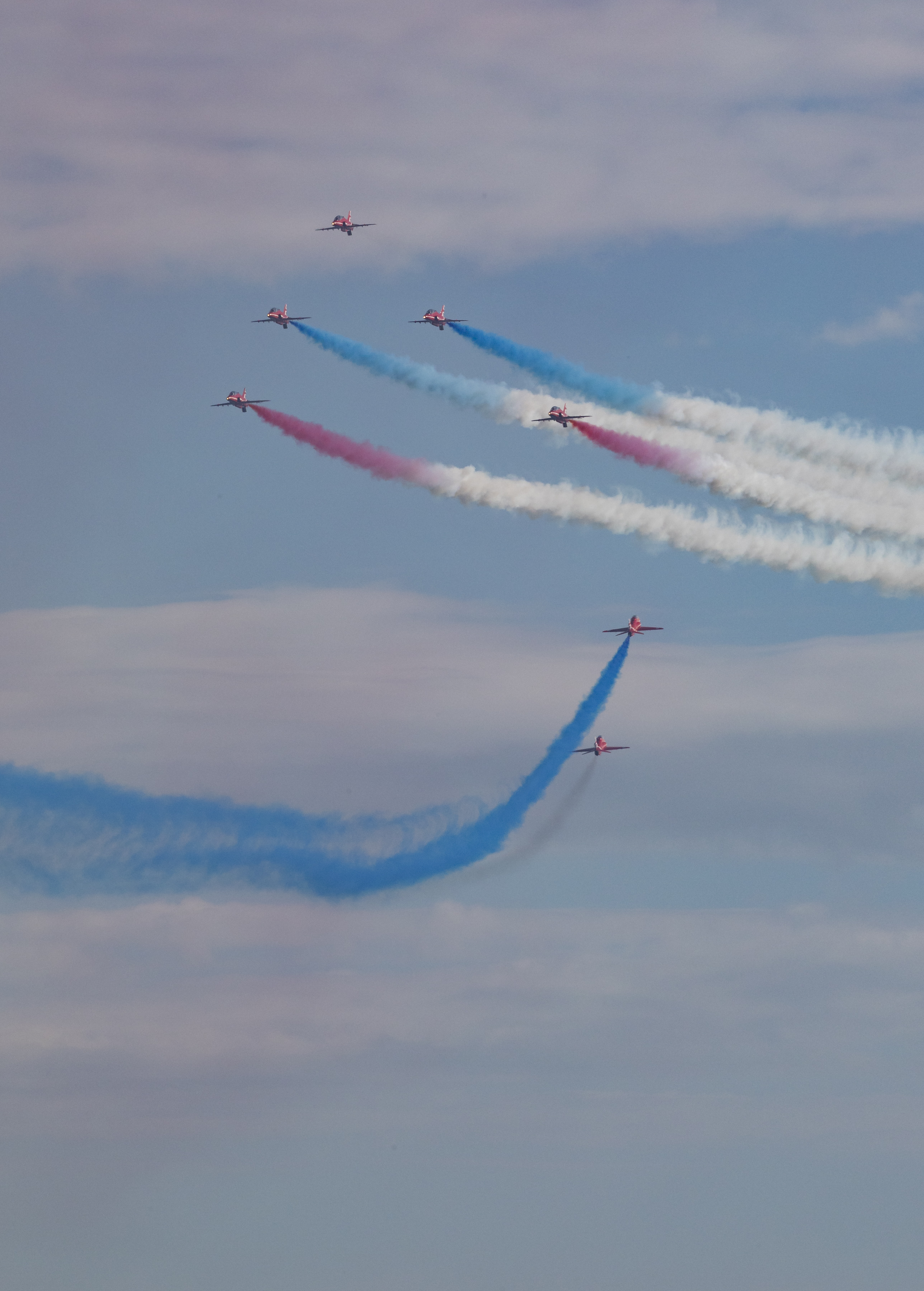 Image of the RAF Red arrows performing with Union Jack smoke trails.